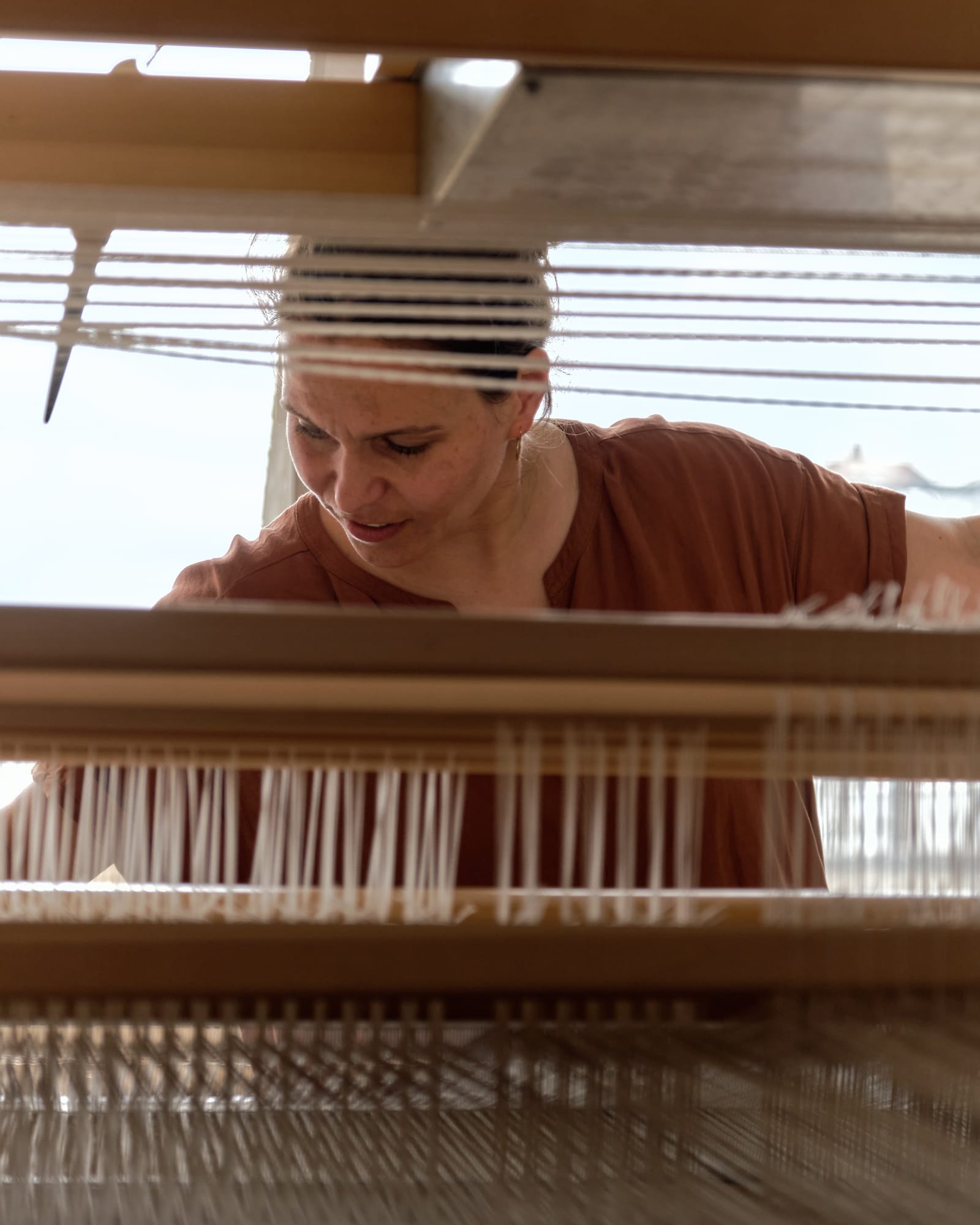 Catarina working at her Finnish-made loom in her studio.