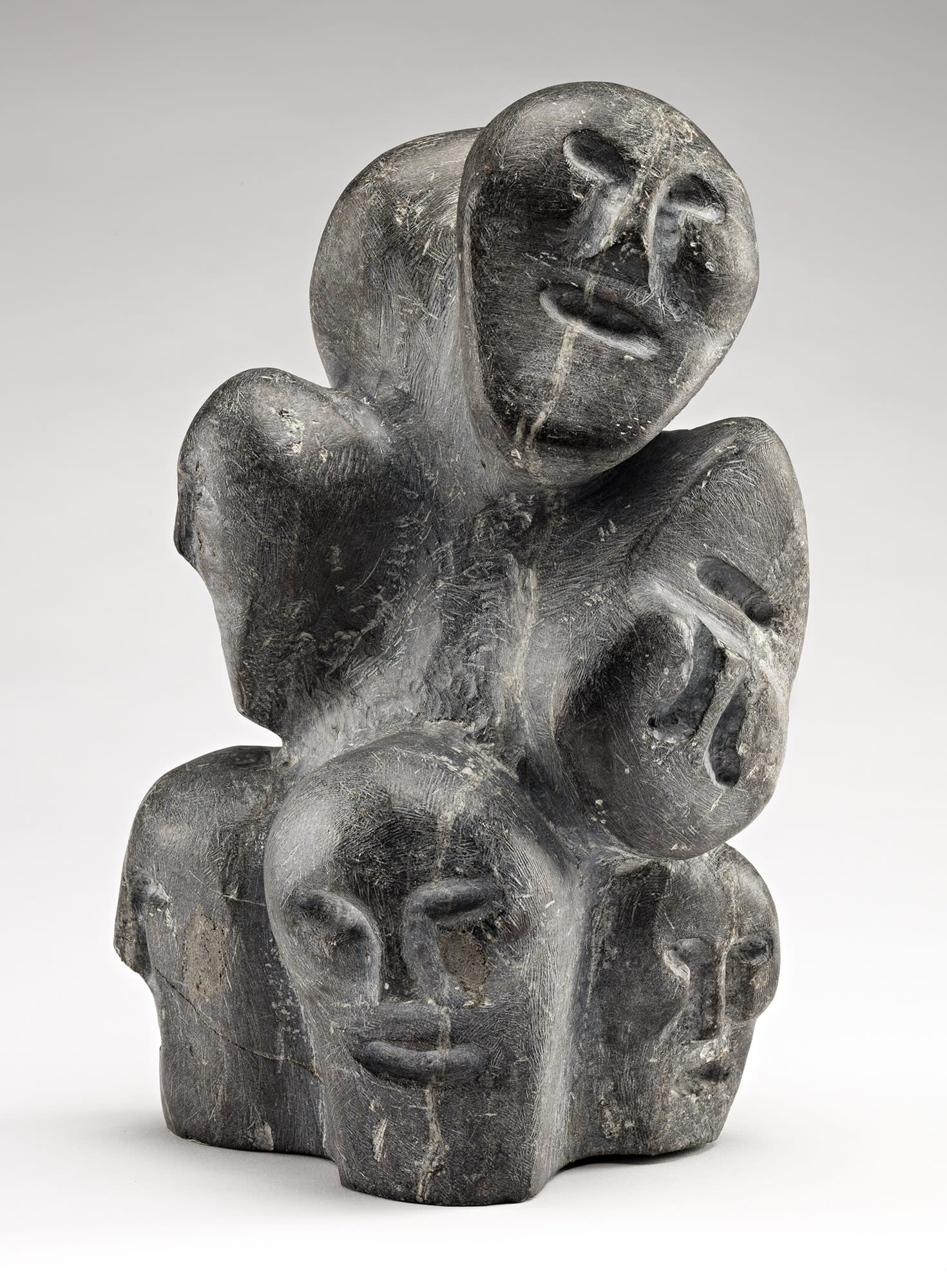Lot 18 JOHN TIKTAK, R.C.A. (1916-1981) KANGIQLINIQ (RANKIN INLET) Composition with Many Faces, 1974 stone, 12 x 6.5 x 6 in (30.5 x 16.5 x 15.2 cm) Estimate: $25,000 — $35,000 Price realized: $24,000