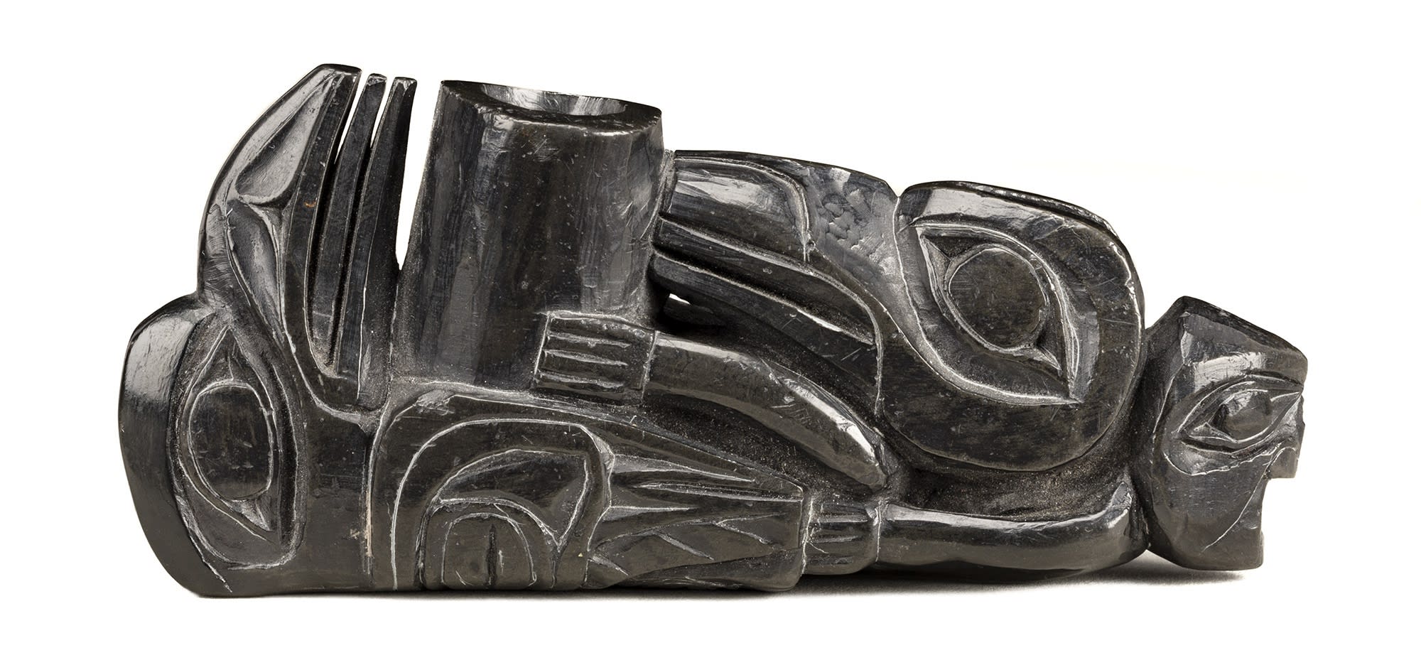 Lot 53 UNIDENTIFIED ARTIST, HAIDA Ceremonial Pipe, c. 1830s argillite with metal stand, 4 x 5.25 x 1.5 in (10.2 x 13.3 x 3.8 cm) Estimate: $3,000 — $5,000 Price realized: $3,360