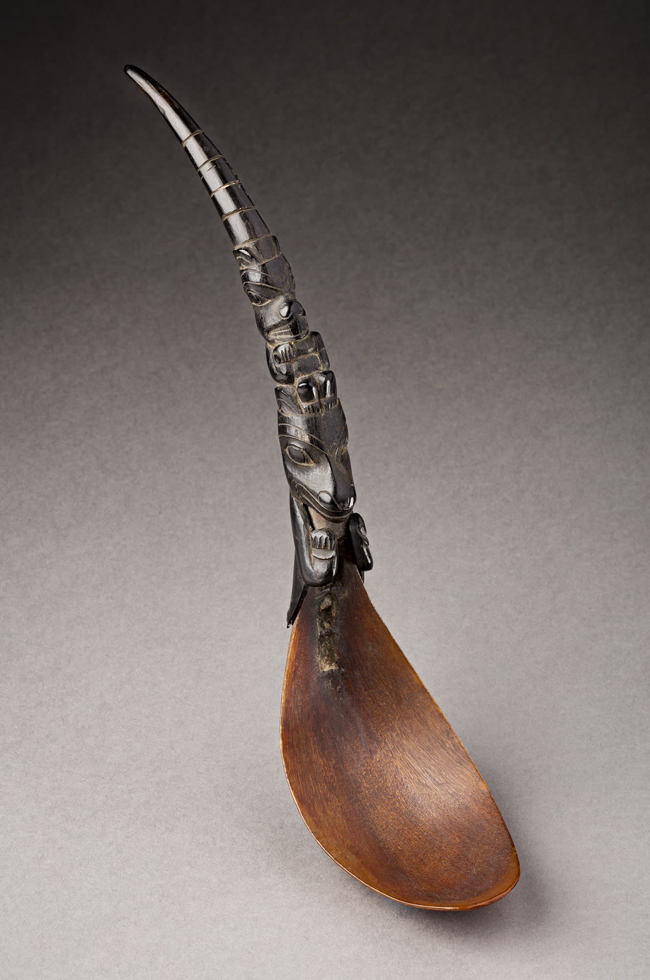 Lot 78 UNIDENTIFIED MAKER, HAIDA OR POSSIBLY TLINGIT Feast Spoon, late 19th century mountain goat horn and mountain sheep horn, metal rivet, 9 x 3.5 x 2 in (22.9 x 8.9 x 5.1 cm). Estimate: $800⁠⁠⁠— $1,200 price realized: $4,080