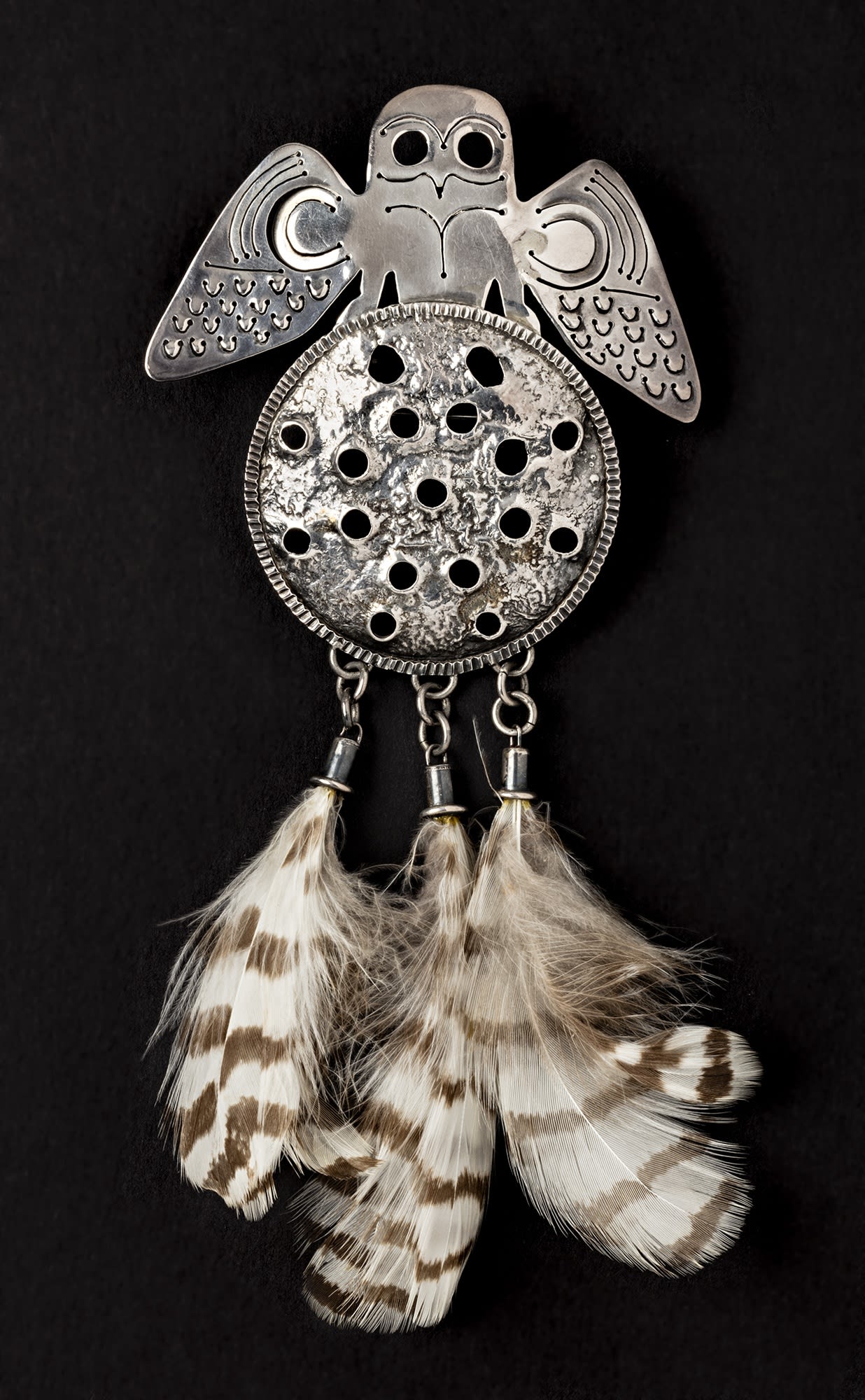 Lot 79 PITALOOSIE SAILA, R.C.A. (1942-) f., KINNGAIT (CAPE DORSET) Brooch: Owl Standing on the Moon, 1974-75 silver and feathers, 7.5 x 3.75 x .75 in (19.1 x 9.5 x 1.9 cm) Estimate: $800— $1,200 price realized: $540