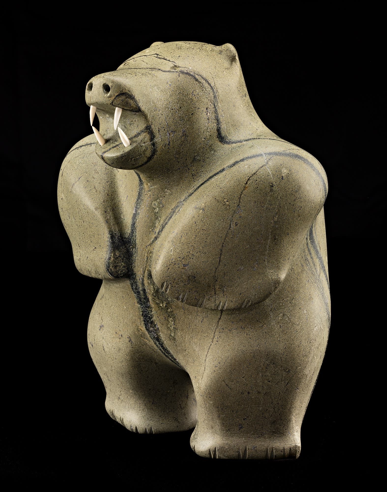 Lot 88 PAUTA SAILA, R.C.A. (1916-2009) m., KINNGAIT (CAPE DORSET) Standing Polar Bear, early 1970s stone and ivory, 12 x 8.75 x 9 in (30.5 x 22.2 x 22.9 cm) Estimate: $20,000— $30,000 Price realized: $20,400