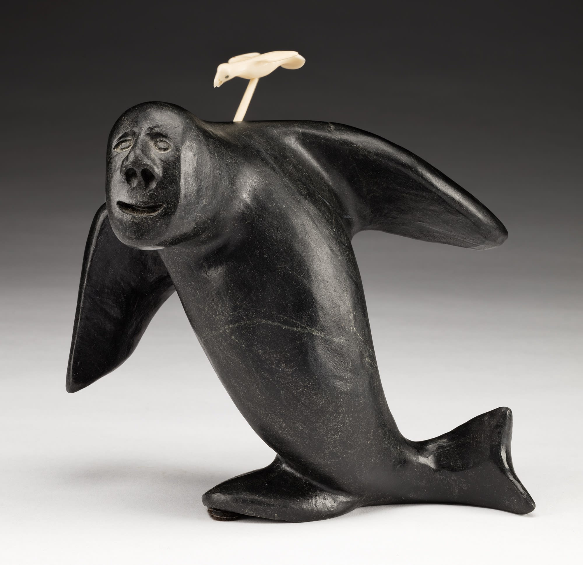 Lot 95 JOSIAH NUILAALIK (1928-2005), QAMANI'TUAQ (BAKER LAKE) Transforming Shaman with Spirit Bird, 2001 stone, antler, and black colouring, 7.5 x 7.5 x 3.5 in (19.1 x 19.1 x 8.9 cm) Estimate: $5,000— $8,000 Price realized: $5,280