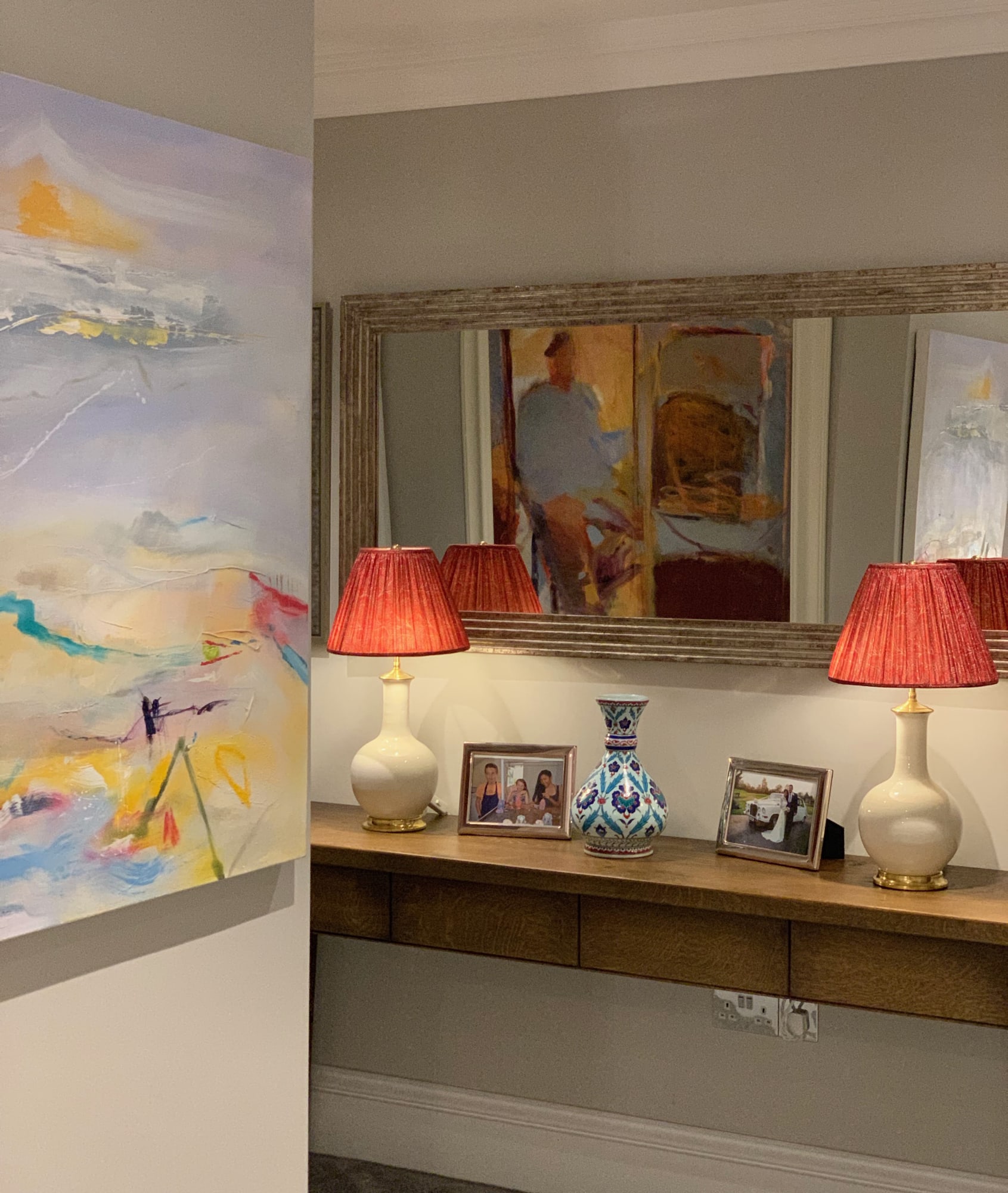 An eclectic mix of paintings, with an abstract by Heidi Koenig and a self portrait by Rose Hilton