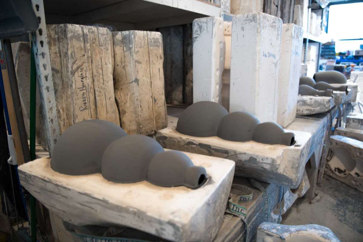 The lamps are first slip-cast by an artisan using a plaster mold and allowed to set for a day