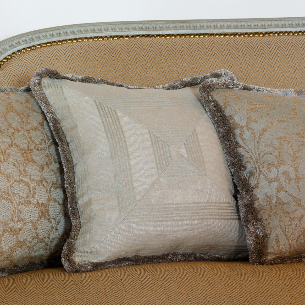 We can mitre fabrics to give this look on bespoke cushions