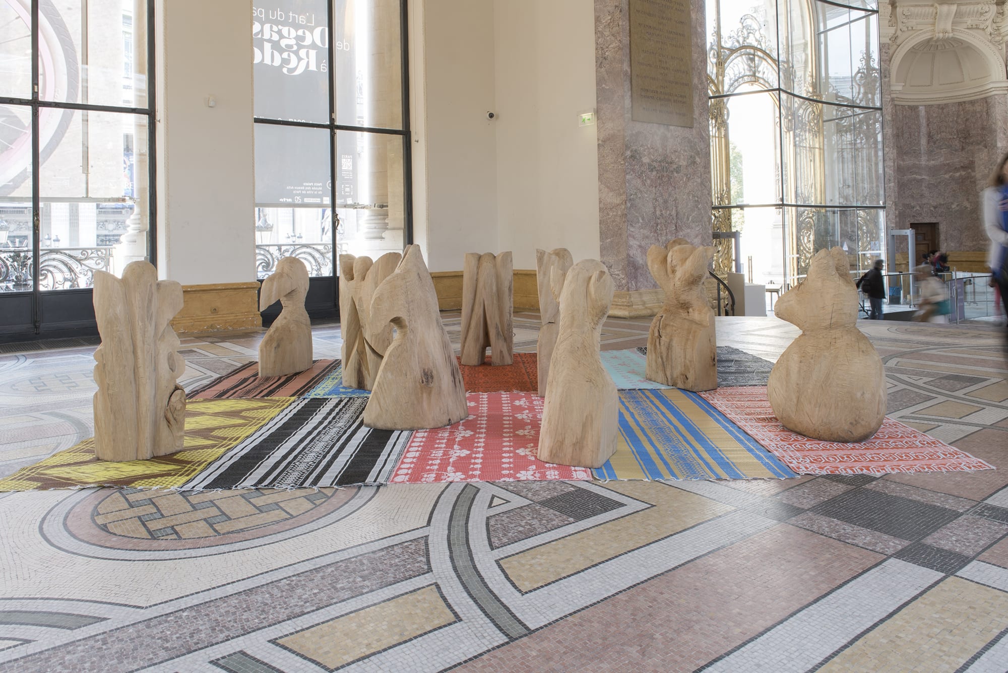 Barth&eacute;l&eacute;my Toguo Crazy City, 2017 10 lime tree wood sculptures, 12 African carpets dimensions variable