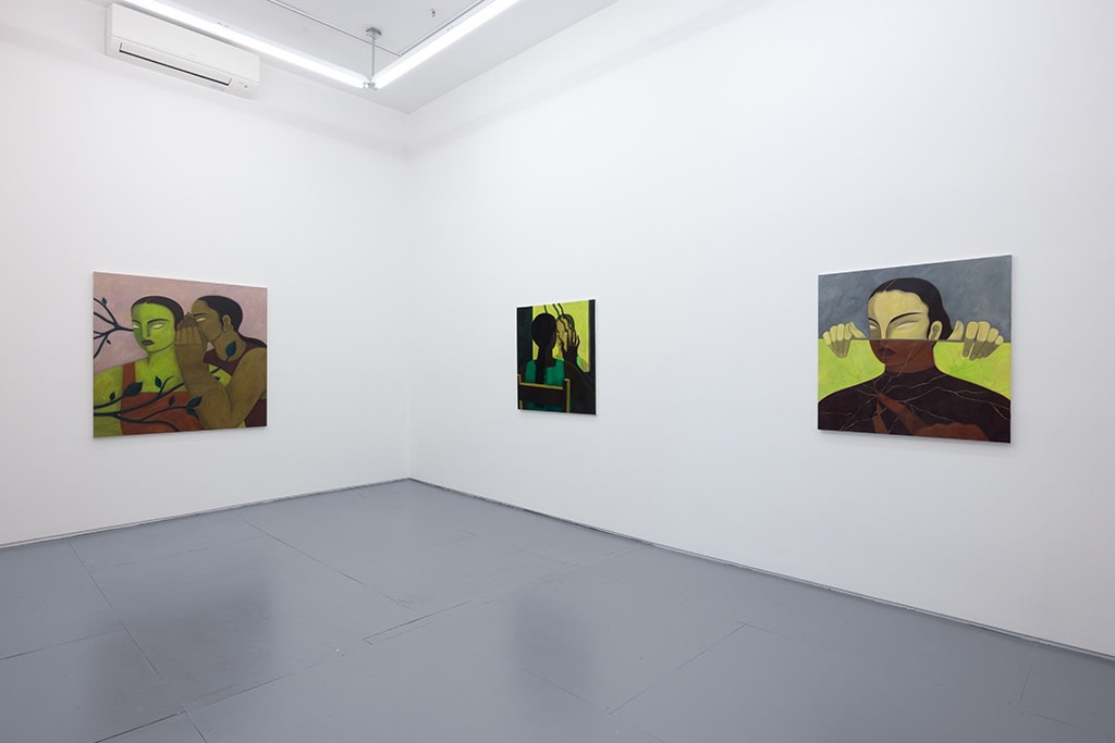 Installation photo of Hilda Palafox paintings of green women