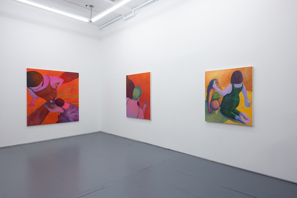 Installation image of red and yellow Genevieve Cohn paintings