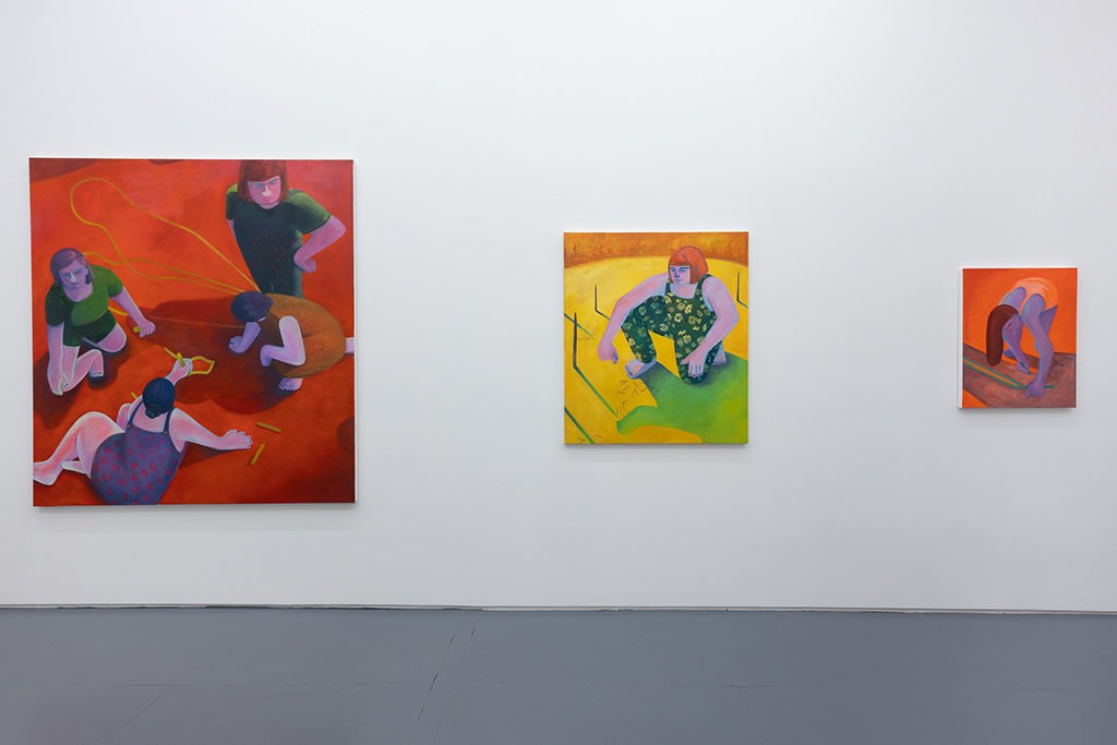 Installation image of red and yellow Genevieve Cohn paintings
