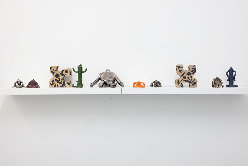 installation picture of Jocelyn Tsaih's "The Garden is Open" featuring a shelf of small colorful statues