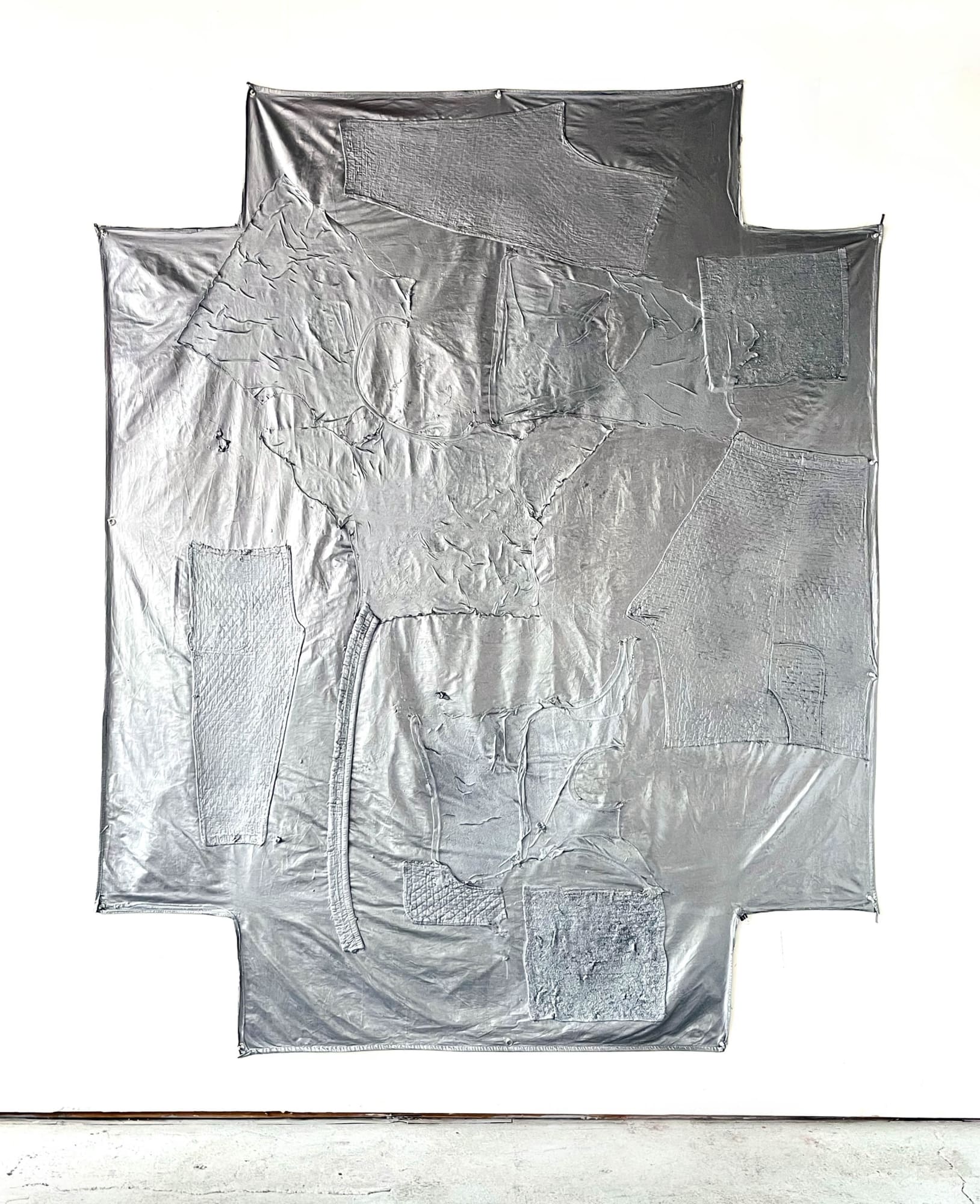 Tamen Pérez Silver Capsule, 2023 Smashed phone charger, worn clothes, acrylic paint and flashe on fitted cotton bedsheet 96 x 120 inches 243 x 304 cm