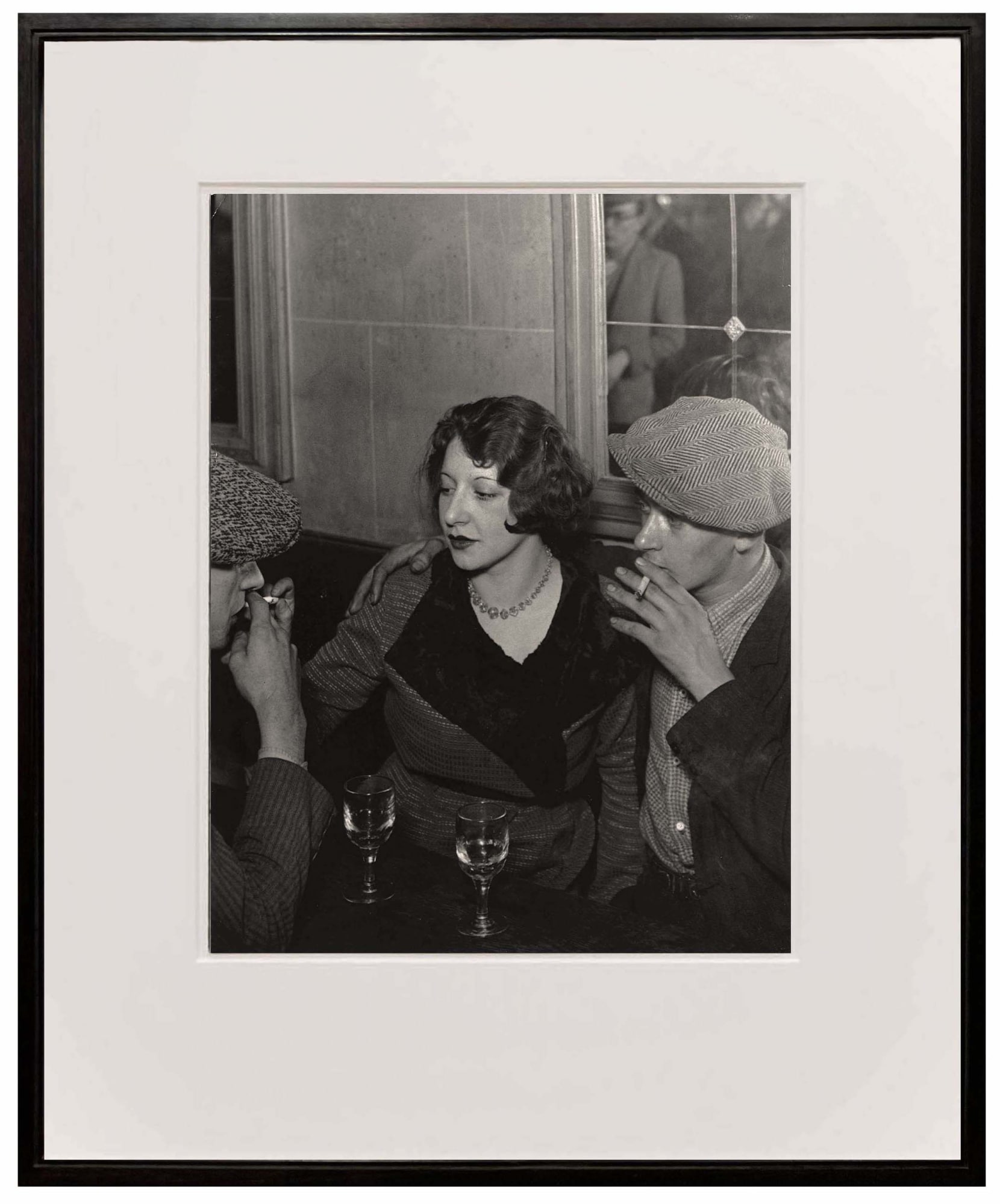 framed photograph of couple at the table smoking cigarette from Paris de Nuit by Brassai