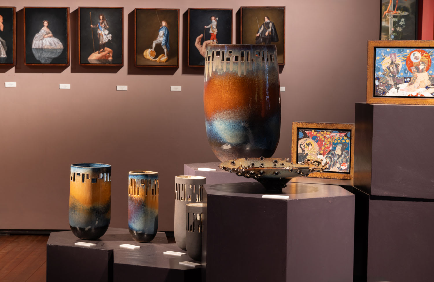 Allison Weightman's ceramics with Rory Macdonald's portraits behind.