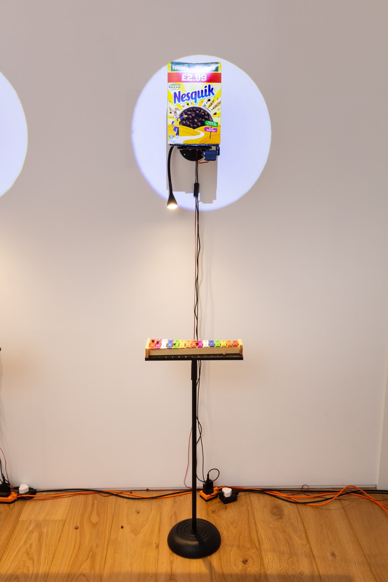 Clara Hastrup Do-Re-Mi-Fa-Ce-Re-Al (Nesquik), 2023 Cereal, metal support structure, Arduinos, motors, 3D printed parts, xylophones, metal stand, spotlights