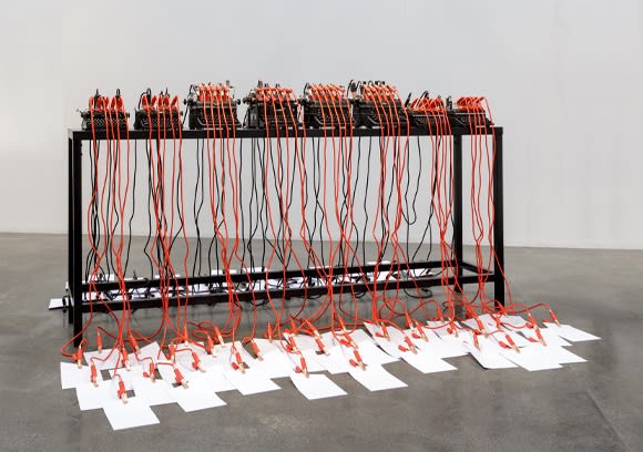 Inside the Fire Circle, 2017 Typewriters, starter cables, papers, table 140 x 300 x 60 cm 55 1/8 x 118 1/8 x 23 5/8 in Edition of 5
