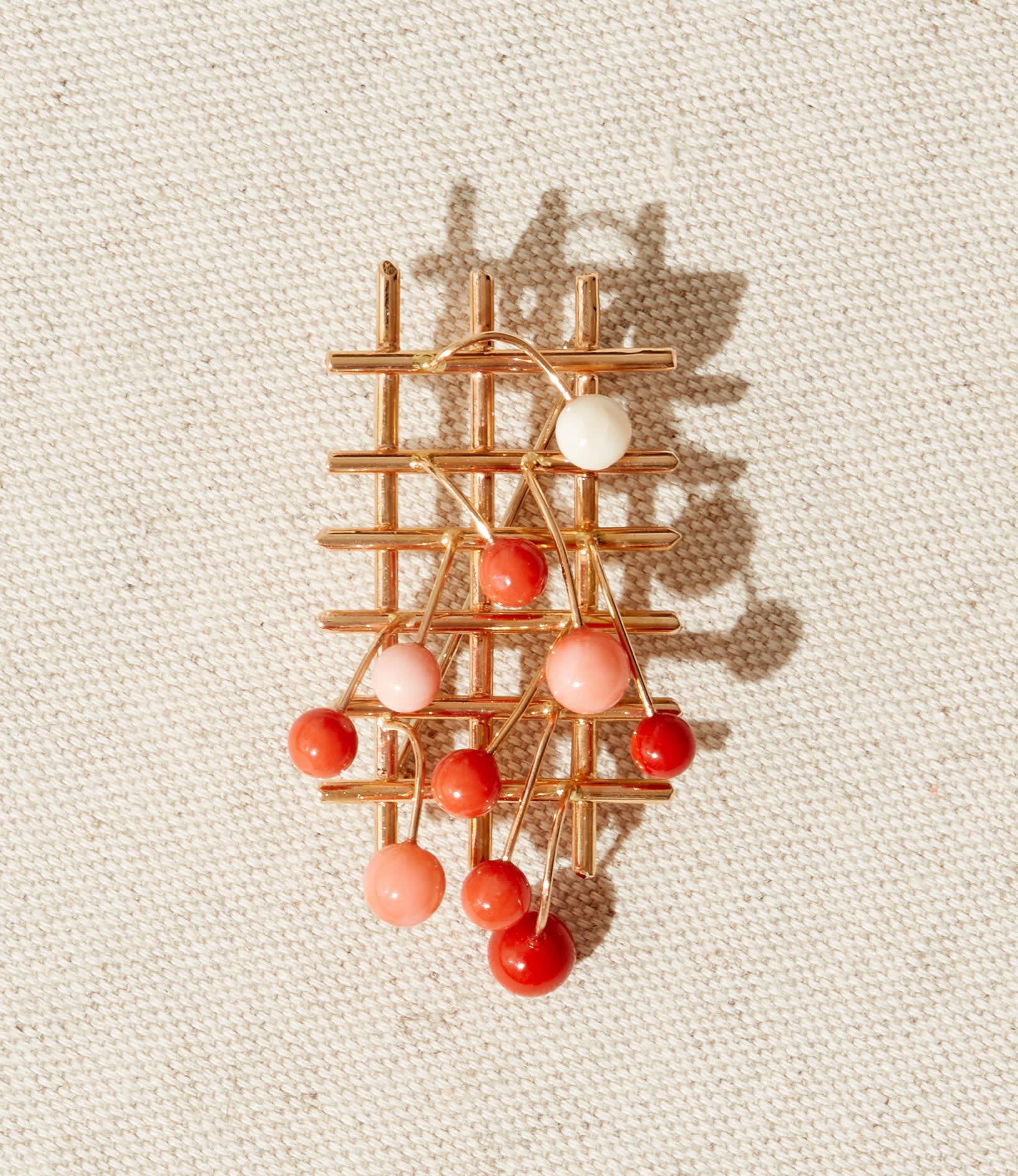 Fausto Melotti, Spilla/Ciondolo ‘Grata’ Brooch/Pendant c.1978, 18k rose gold with 10 coral spheres in red, orange, pink & white and pin on reverse, incised with artist’s signature, numbered & hallmarked, 6.8 x 3.3 x 1.5 cm, 20g, edition of 8 + 4 AP.
