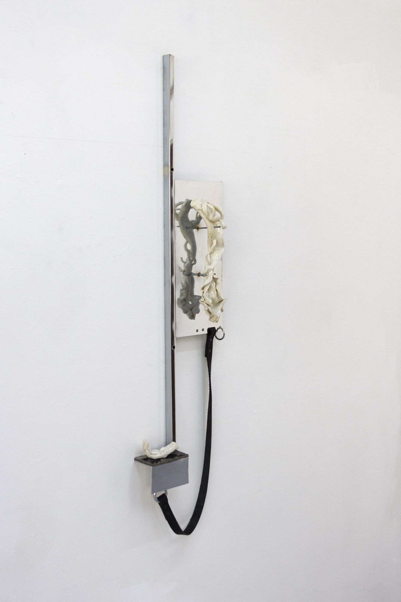 fig 40.3 preta, 2024 Chrome-plated steel, porcelain, leather 58 x 14 x 5 in.