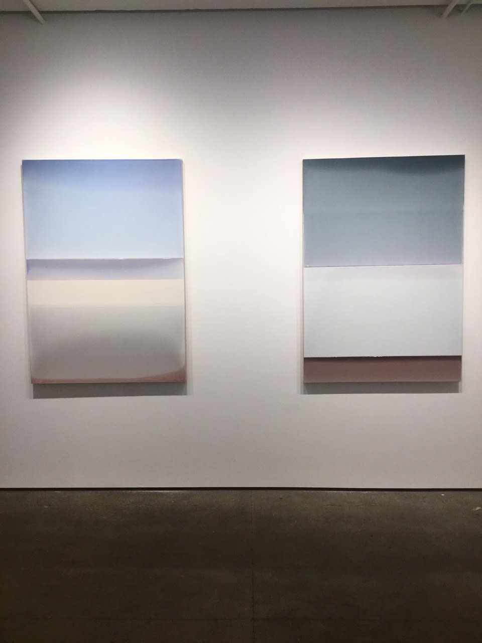 Installation shot of two tinted polymer on panels by Susan English. The works from left to right are "Intervals No. 2", "Intervals No. 1".