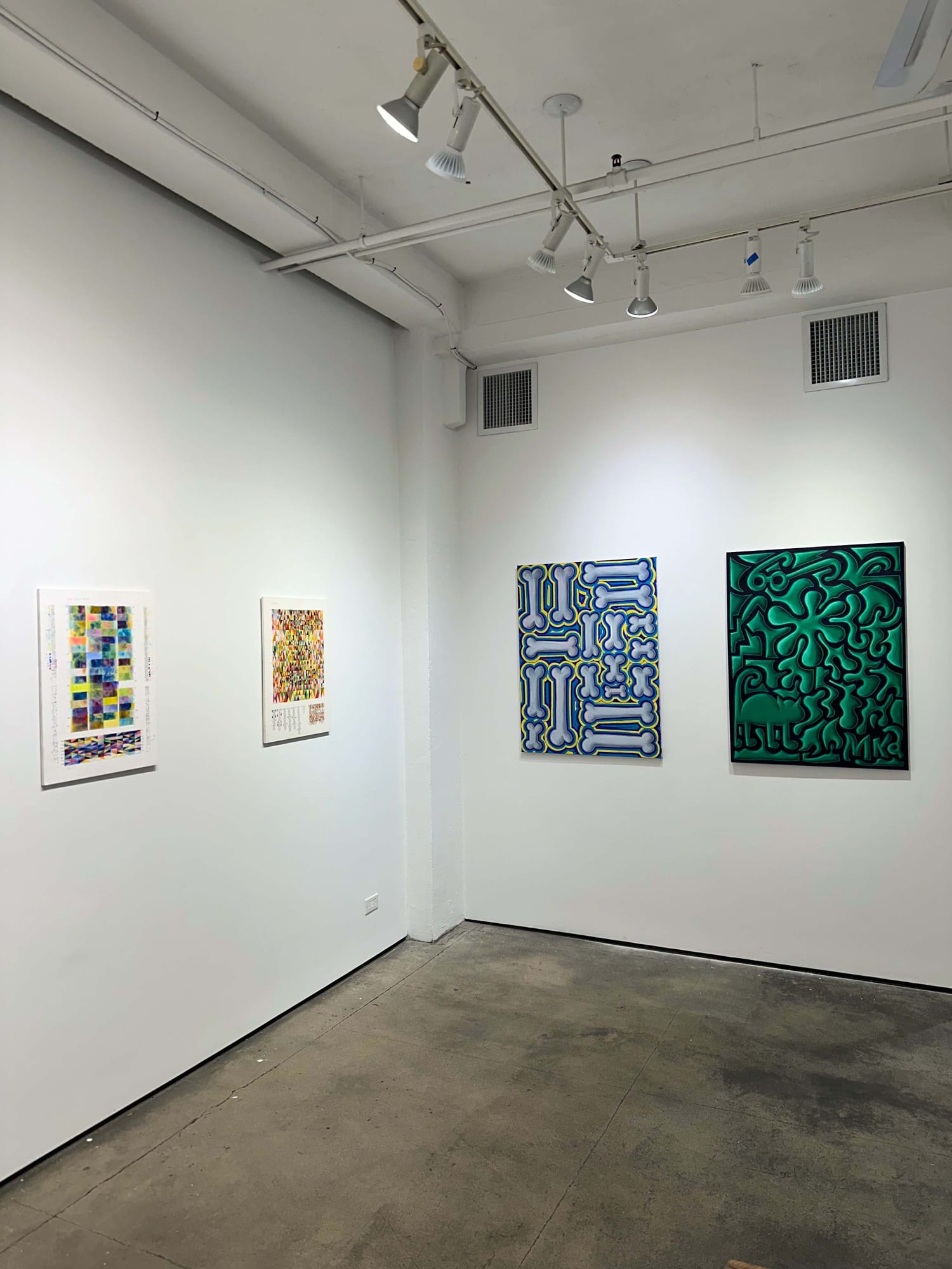 exhibition with four paintings; two on each visible wall