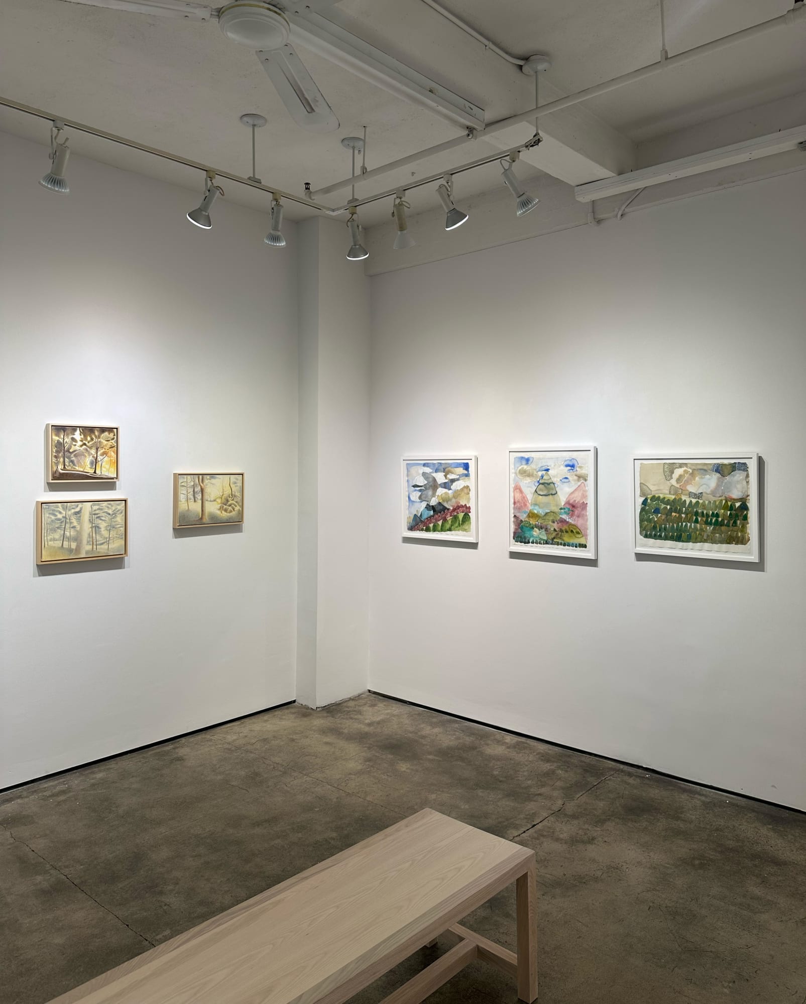 exhibition with six paintings on the two visible walls