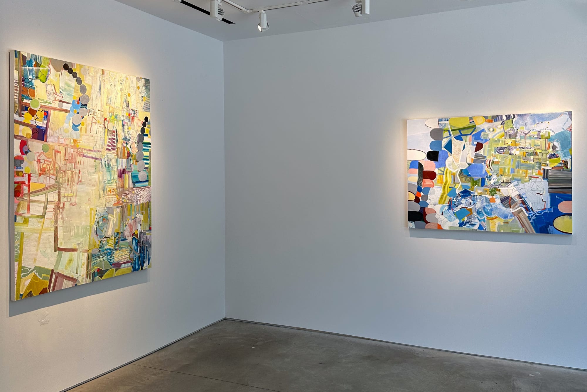 exhibition with two large colorful abstract oil paintings on the walls