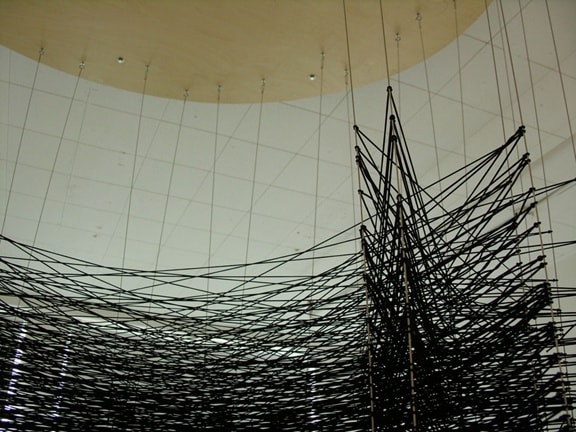 Karilee Fuglem, "There's a place on my back that isn't there" (detail), polyester-wrapped elastic thread, rubber o-rings, steel cables, wood and steel platform