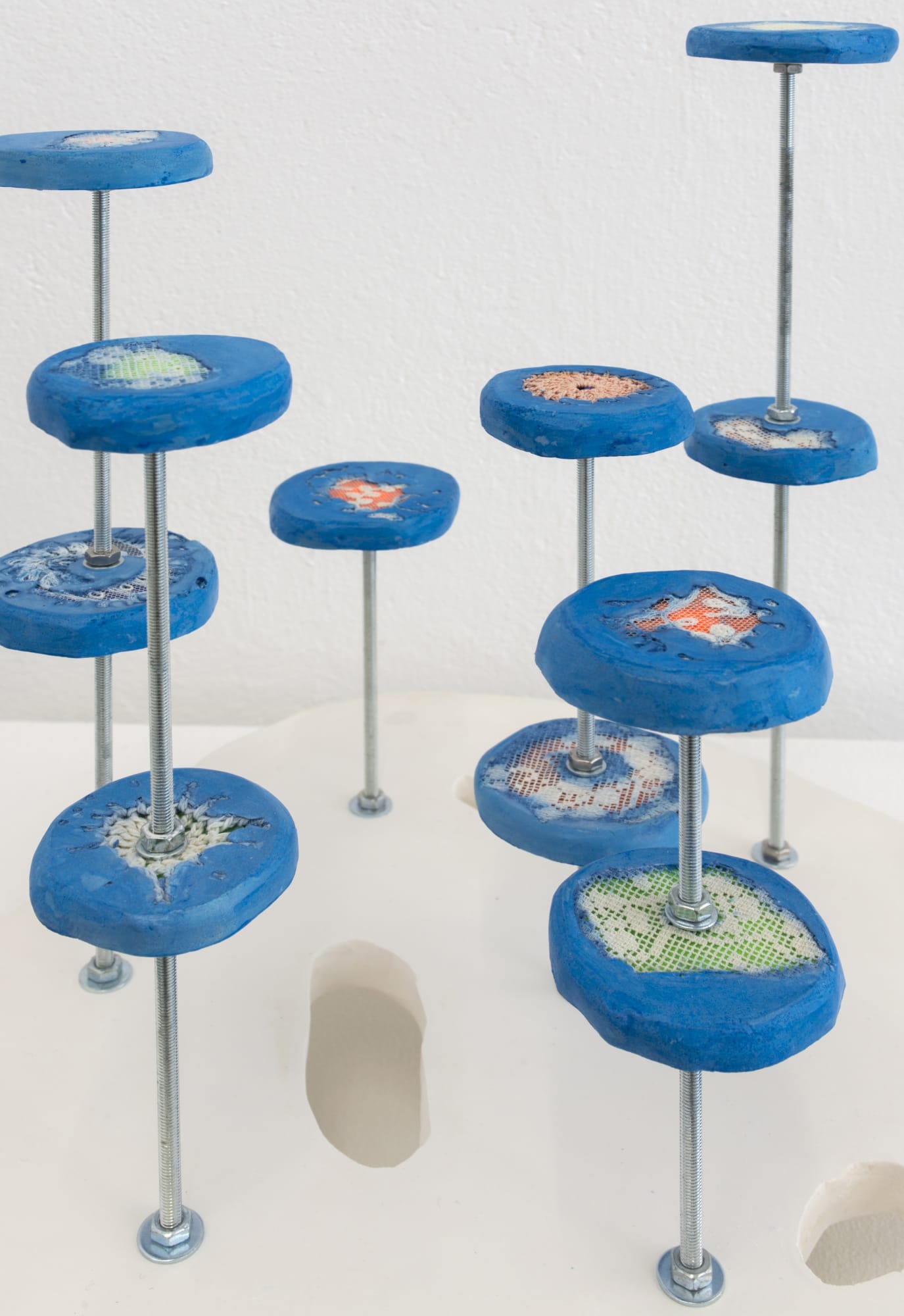 Untitled 2021 Plaster, pigment, crochet doilies, high visibility fabric, swimming costumes, steel 31 x 29 x 26 cm