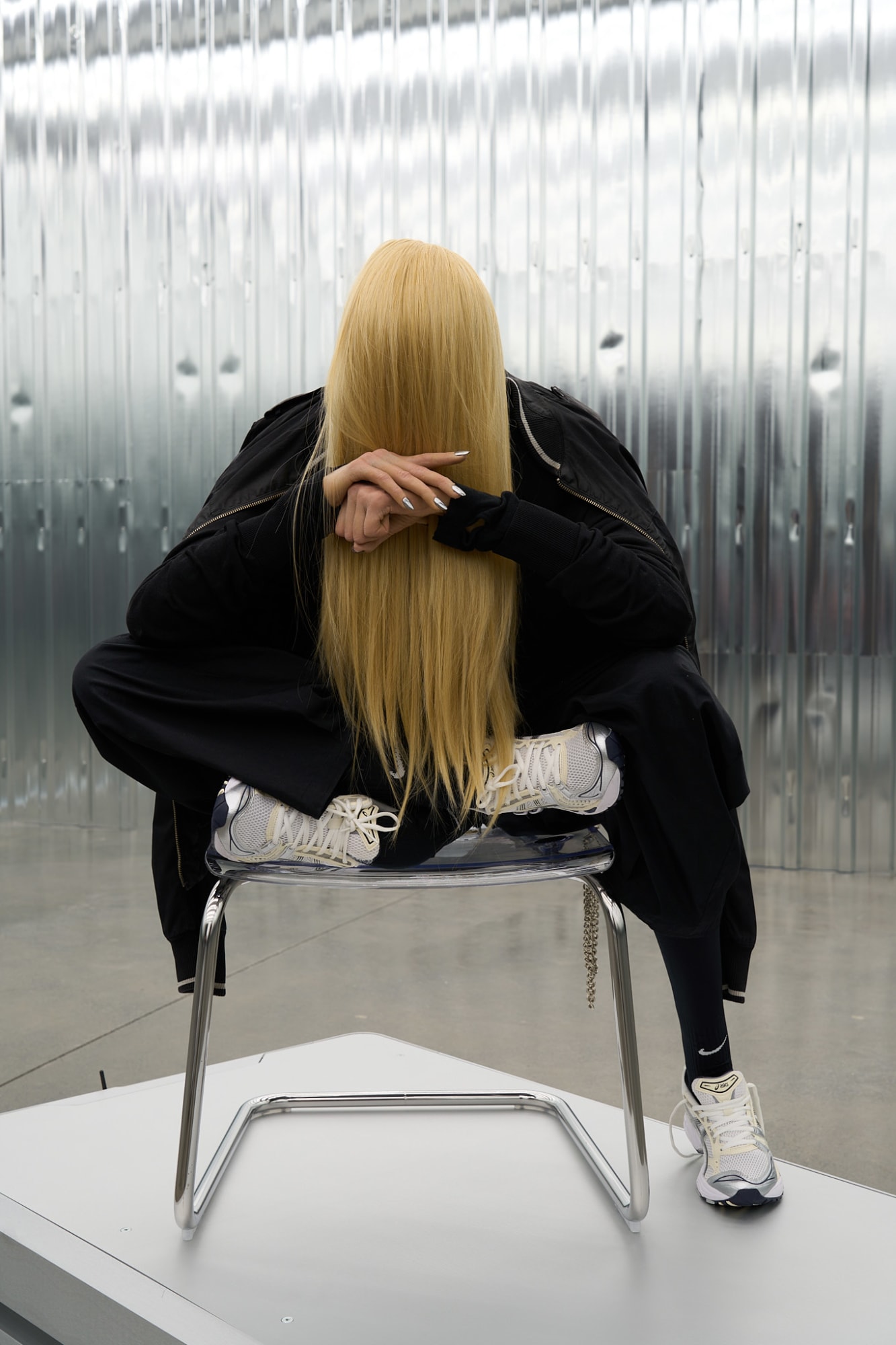 :mentalKLINIK GREY, 2025 PROFILE SERIES OFFLINE-ISH, ALMOST FAMOUS, POST-LOYAL, CANCELABLE, PRIVATE ANGEL, COMFY DYSTOPIAN, SELF-MYTHOLOGIZED, POST-EVERYTHING AI-generated sculpture, mannequin, artificial hair, silicone, clothes, shoes, tobias chair, autonomous mobile robots (140.6 x 90 x 29.5 mm), sound 116 x 88 x 83 Unique