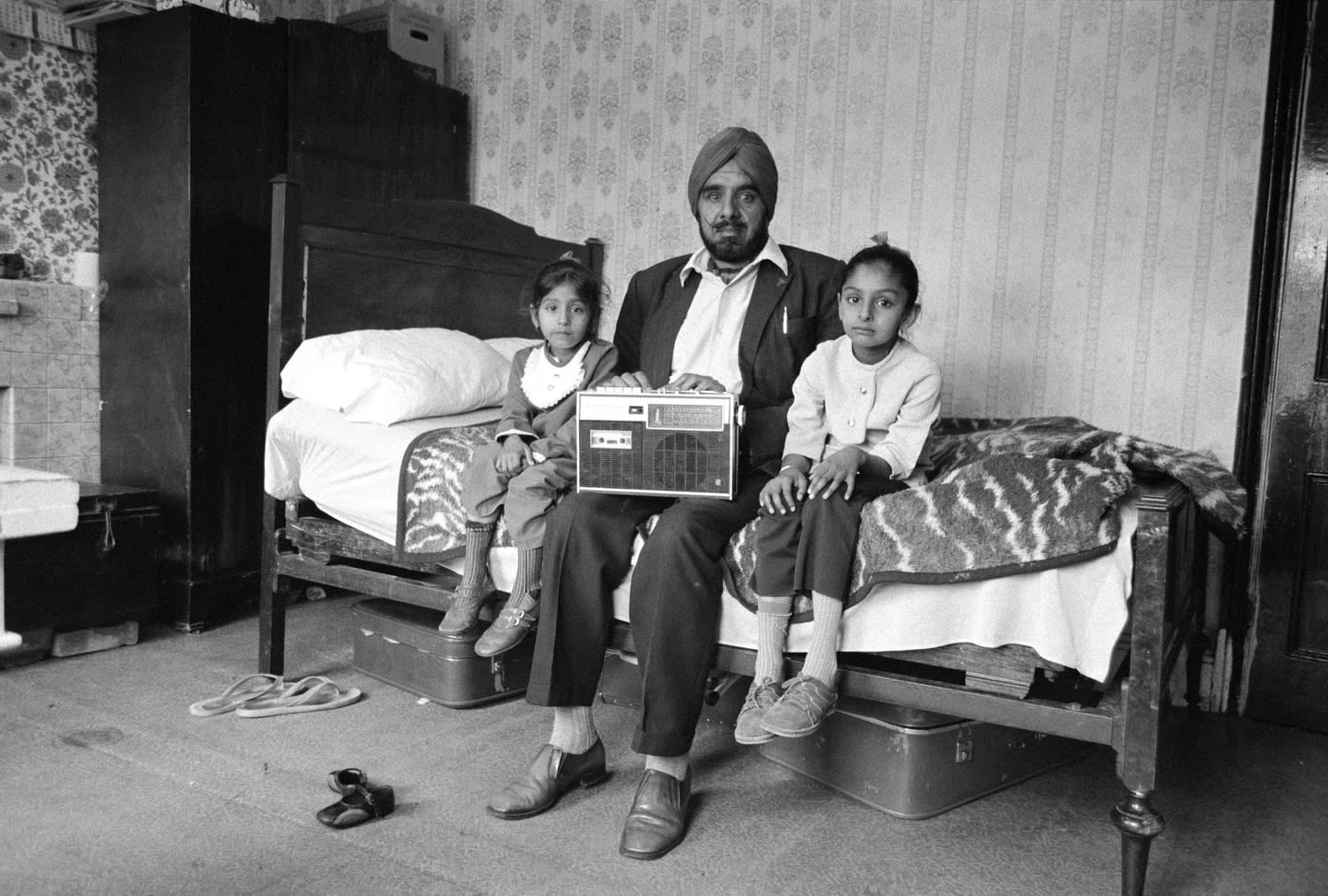Man with his two daughters and his most prized possession, Southall, 1976