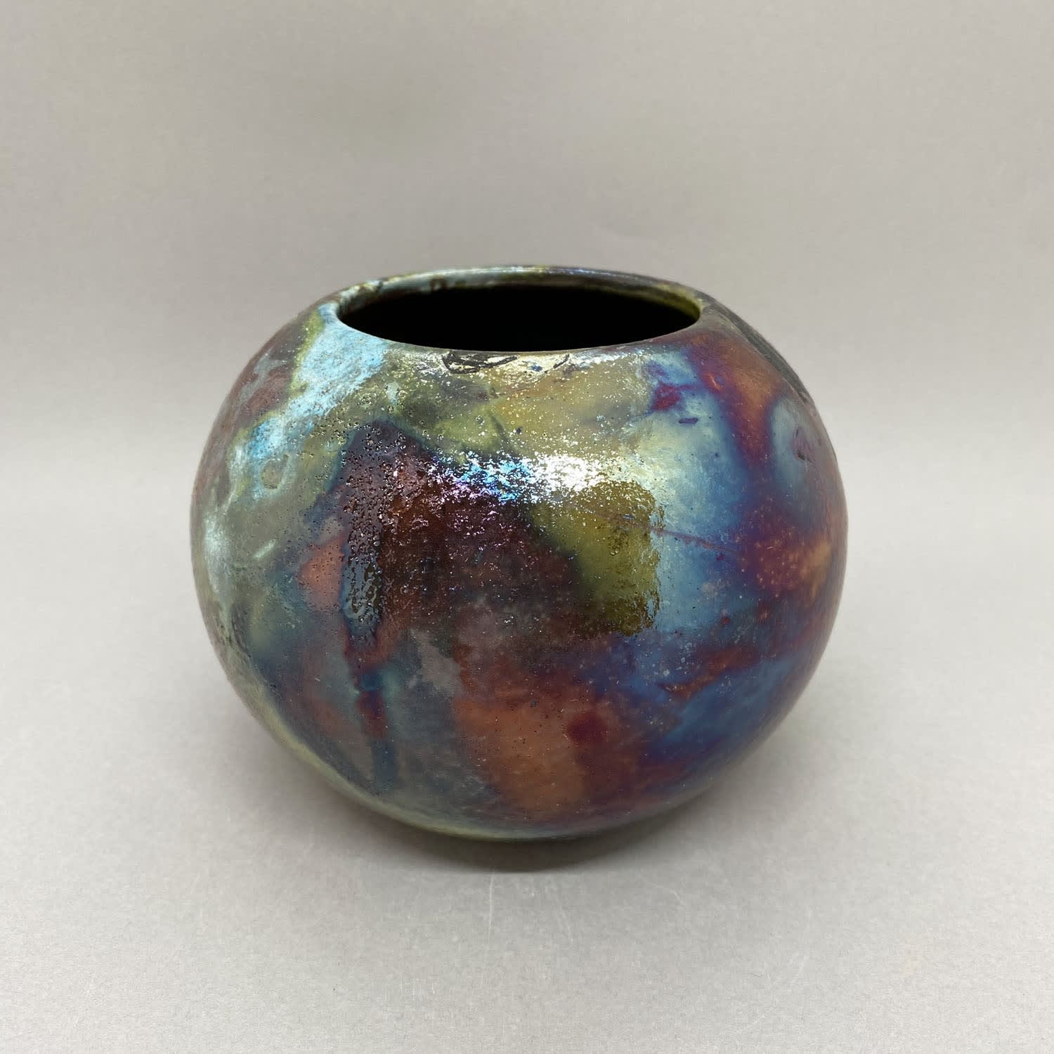 Katie Coston of Illyria Pottery raku fired round vase