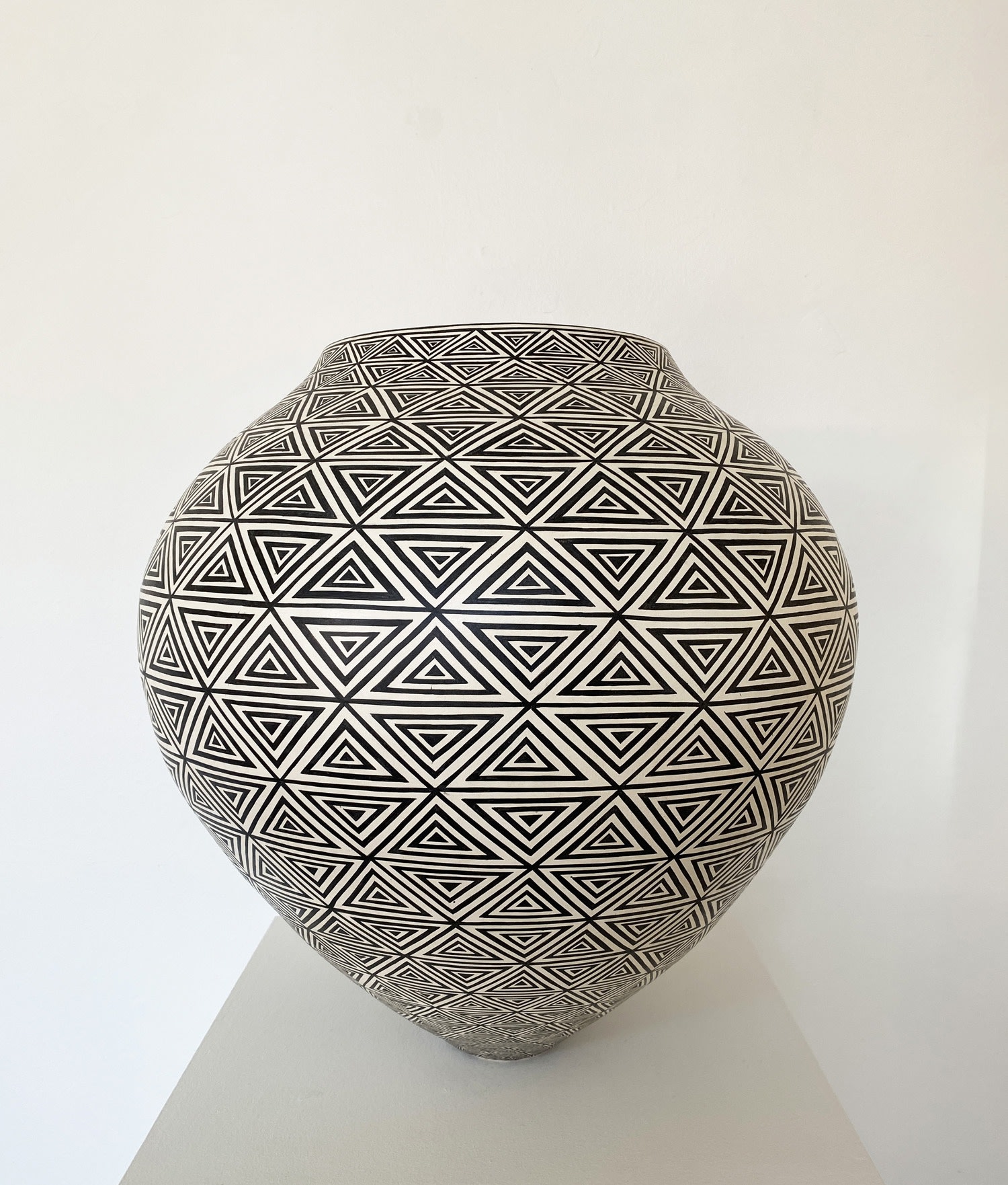 Tydd Pottery wide, rounded ceramic black and white vessel with a complex triangular pattern.