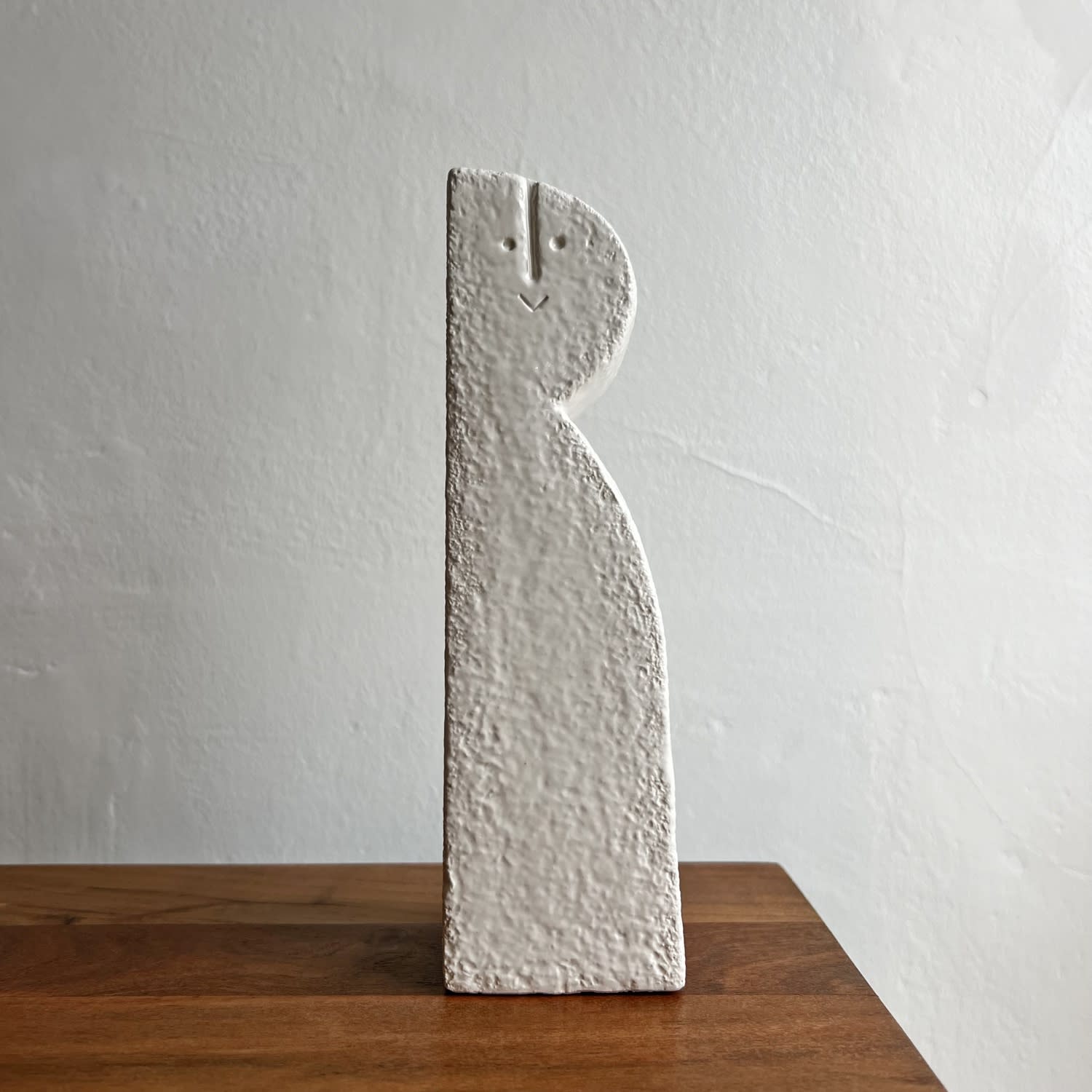 Peter Slight ceramic bust with long body and semi-circular head and abstracted face in eggshell white