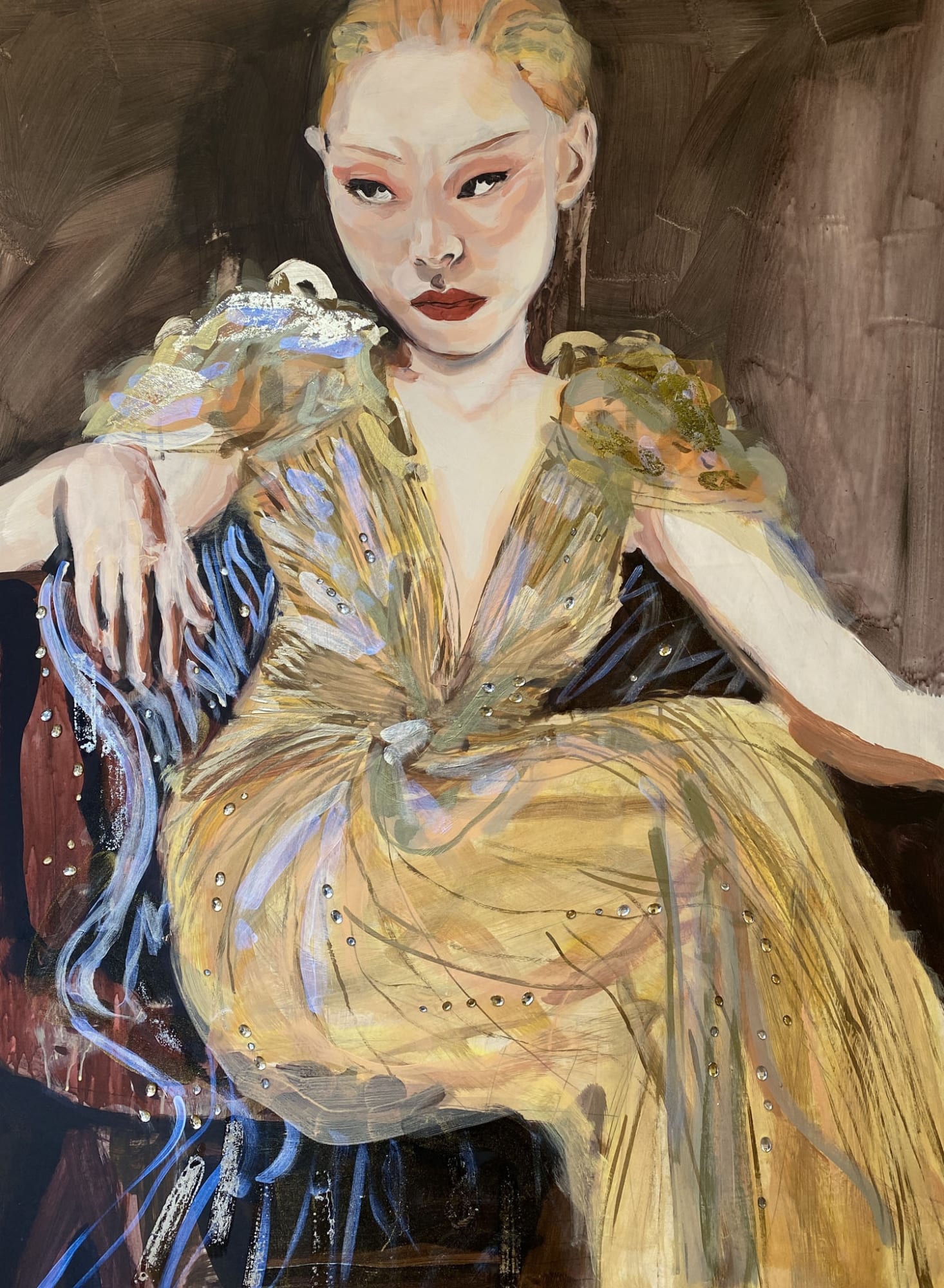 Veronica Wells painting a blond woman sits on a chair wearing a dramatic gold evening dress, dark red background