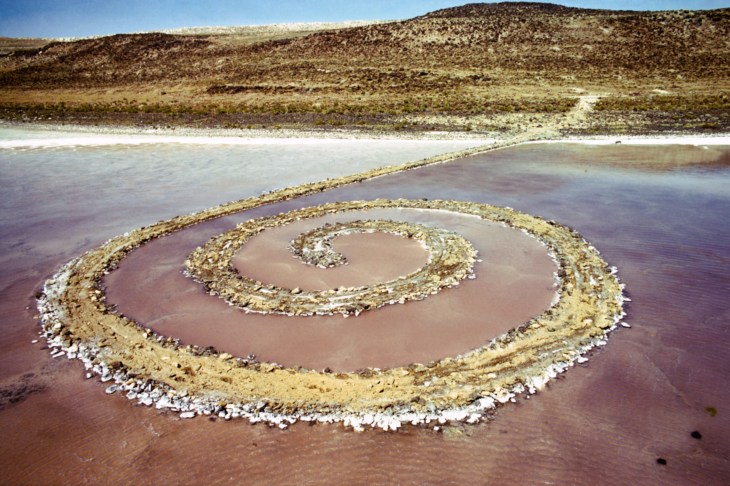 An earthwork by Robert Smithson, containing basalt rocks, salt crystals, earth, and water