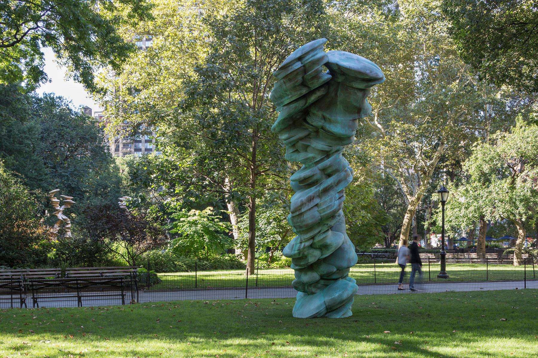 Amorphous green iron tower in a park.