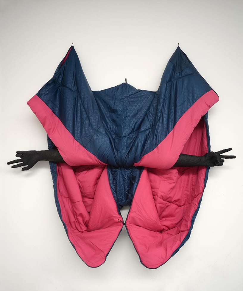 Annette Messager sculpture of a blue and pink coat with arms extended from it