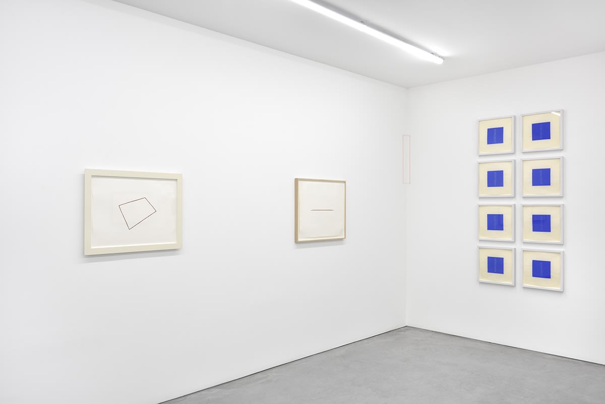 An assortment of small, framed artworks hang in the corner of the gallery. A rectangle is drawn between them.