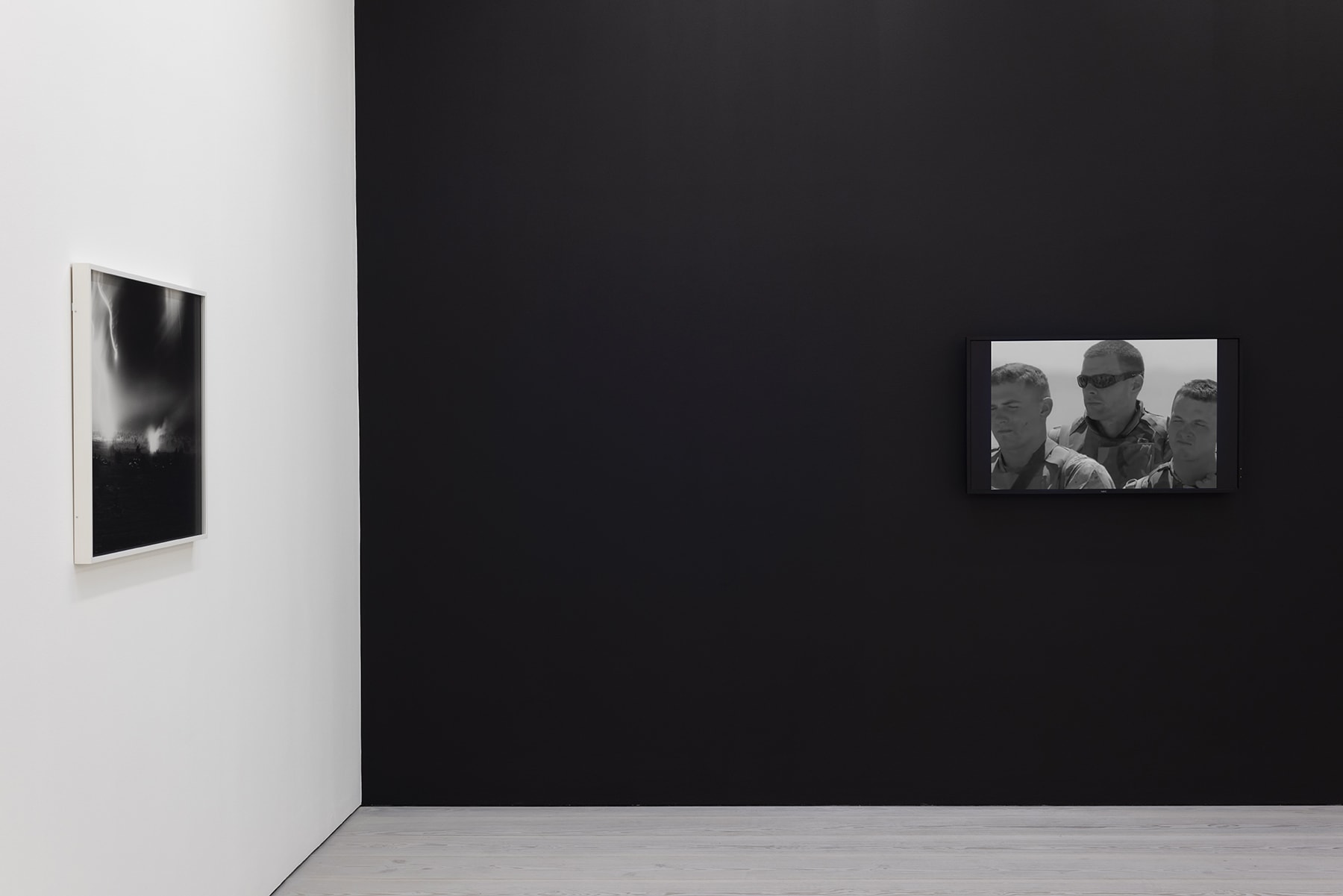 installation view of black and white photographs of war simulation by An-My Le