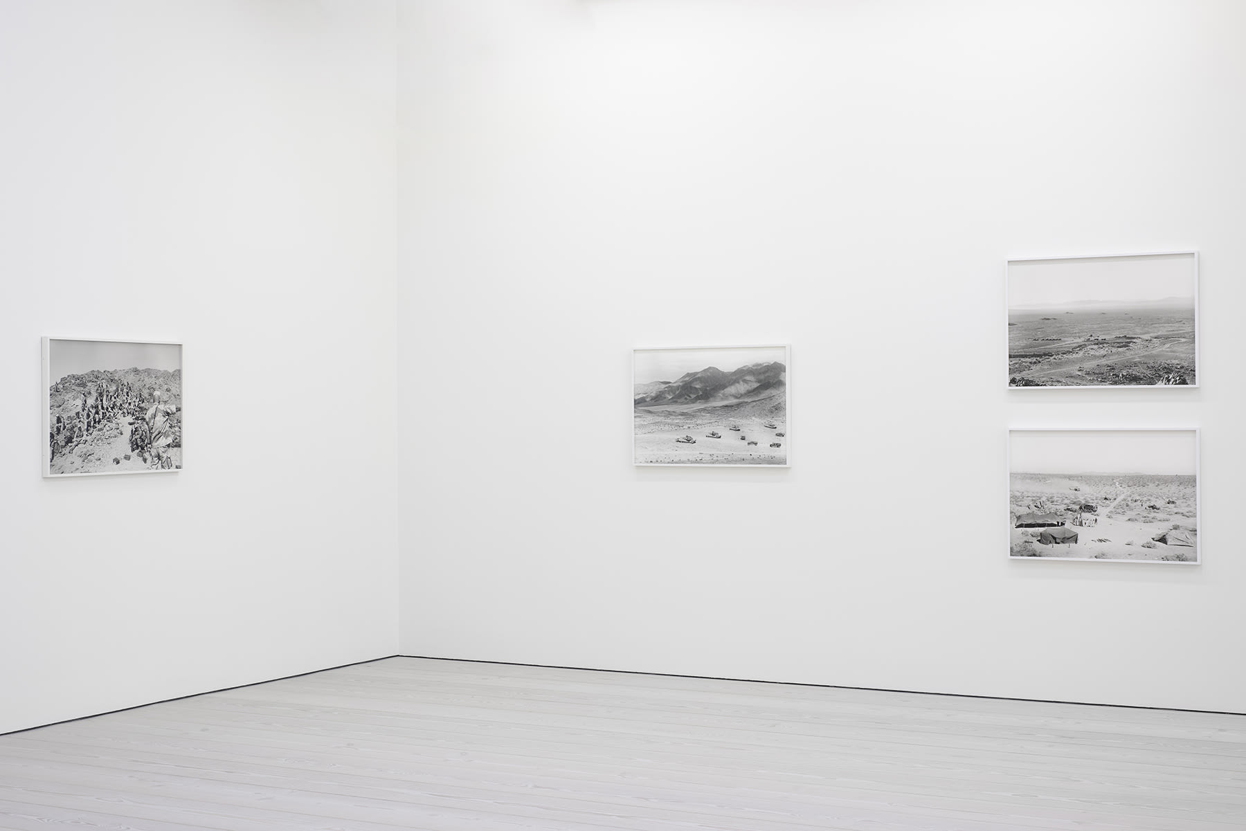 installation view of photographs of war simulations by An-My Le