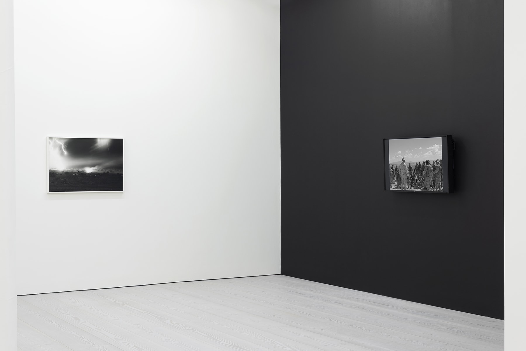 installation view of black and white photographs of war simulation by An-My Le