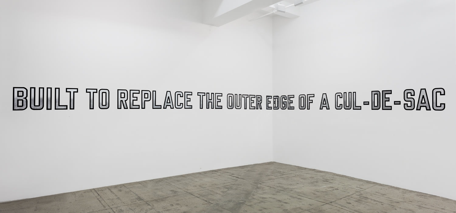 Gallery installation: silver text with black outline reading: BUILT TO REPLACE THE OUTTER EDGE OF A CUL-DE-SAC"