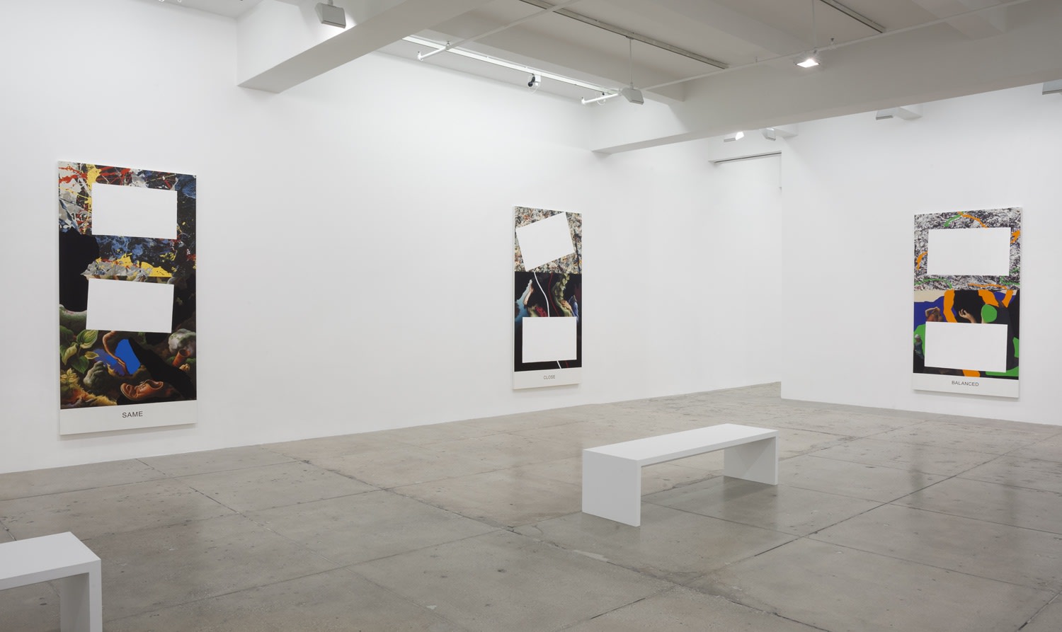 3 paintings partially covered with white rectangles hanging in a gallery space.