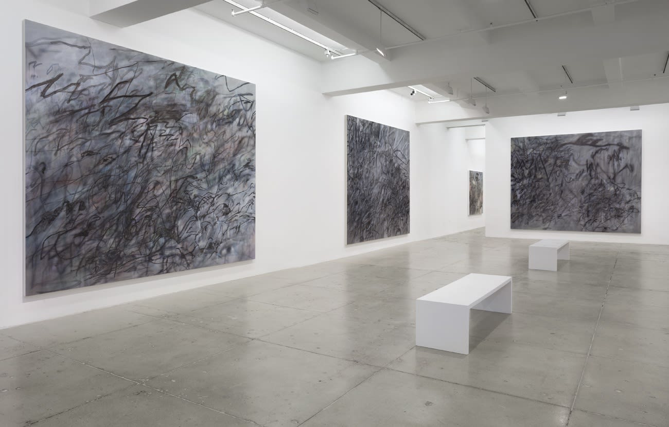 3 large abstract paintings hang in a white gallery space with 2 benches.