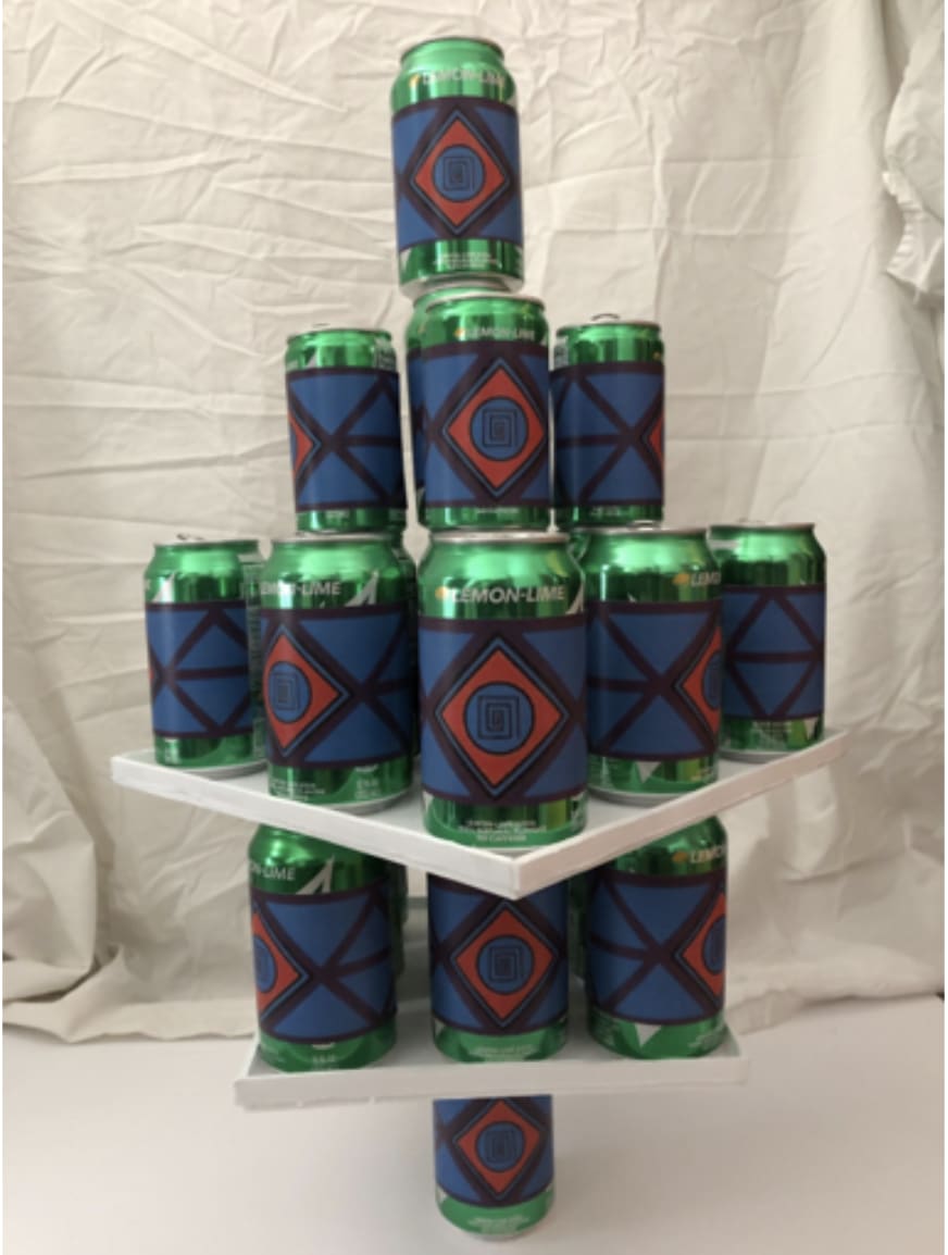 13 green cans stacked on top of each other in a geometric tower