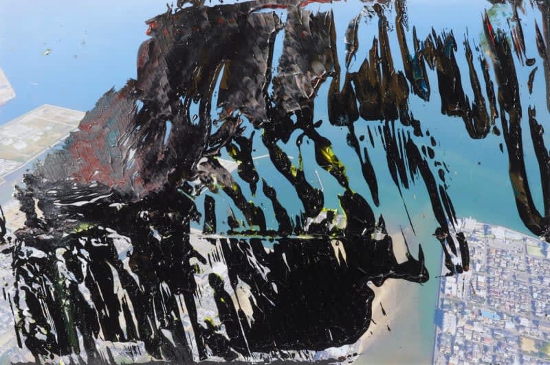 A photograph of an aerial view of a seaport overlaid with thick black paint.