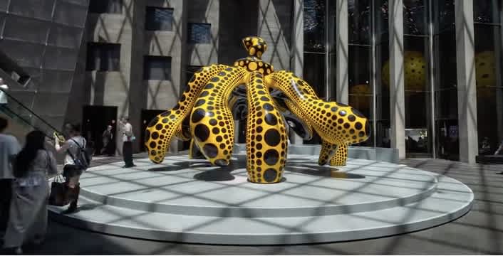 This Yayoi Kusama dancing pumpkin sculpture welcomes visitors to the NGV Yayoi Kusama exhibition.