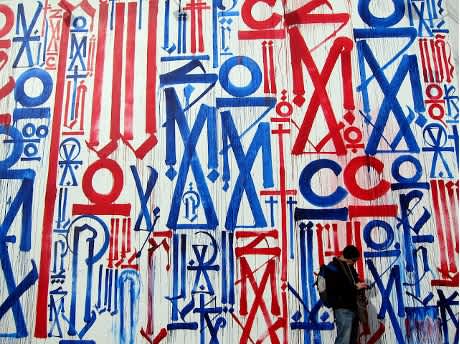 The finished blue and red RETNA mural on the Tony Goldman Wall at Houston & Bowery, NYC (2012)