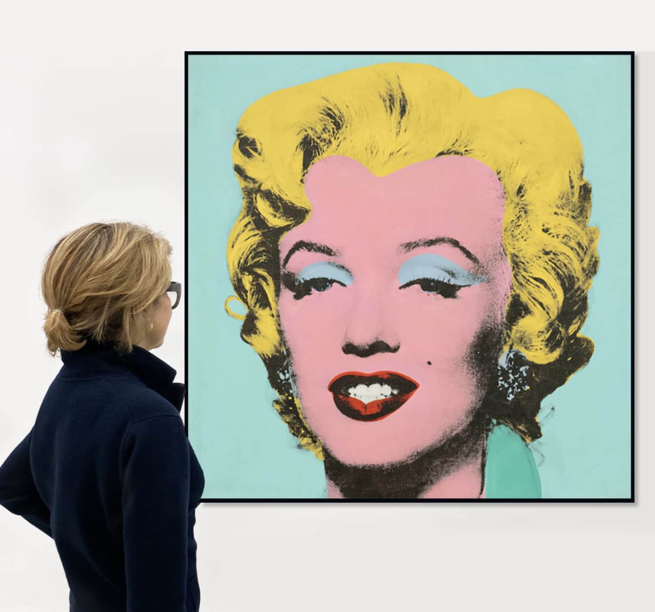 A woman looks at a Marilyn portrait by Andy Warhol, wondering about art investment opportunities within the current global art market.