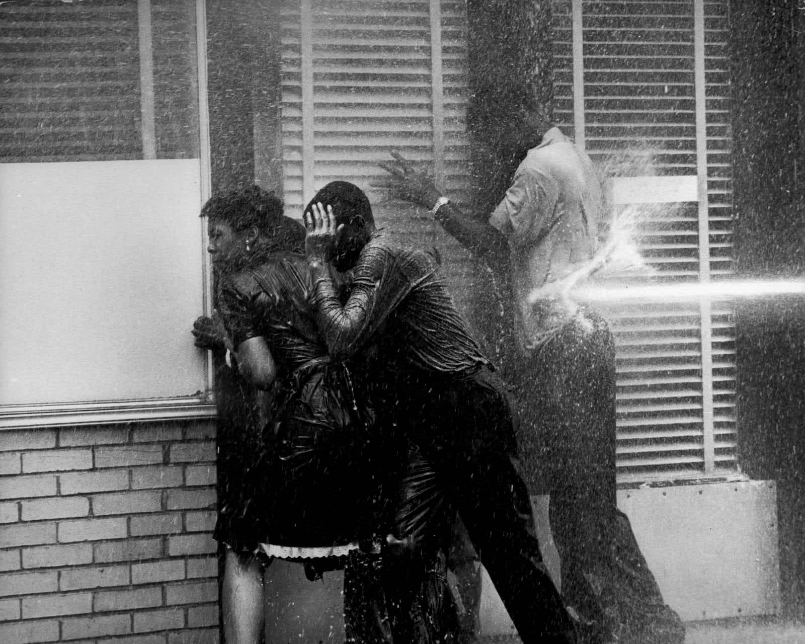 Three People in Doorway Being Fire Hosed, Birmingham, AL